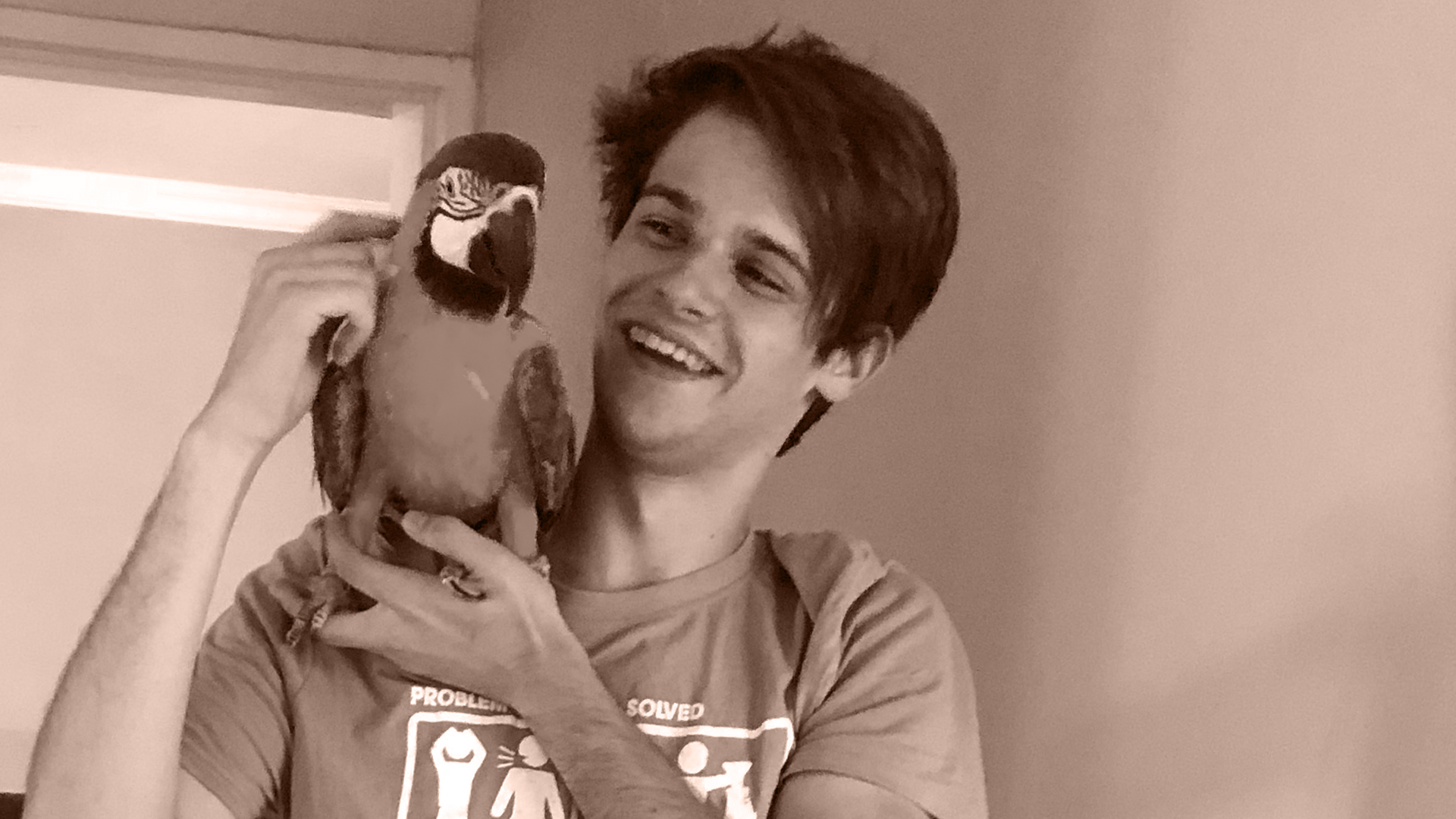 Lanzo with a Macaw parrot on his shoulder