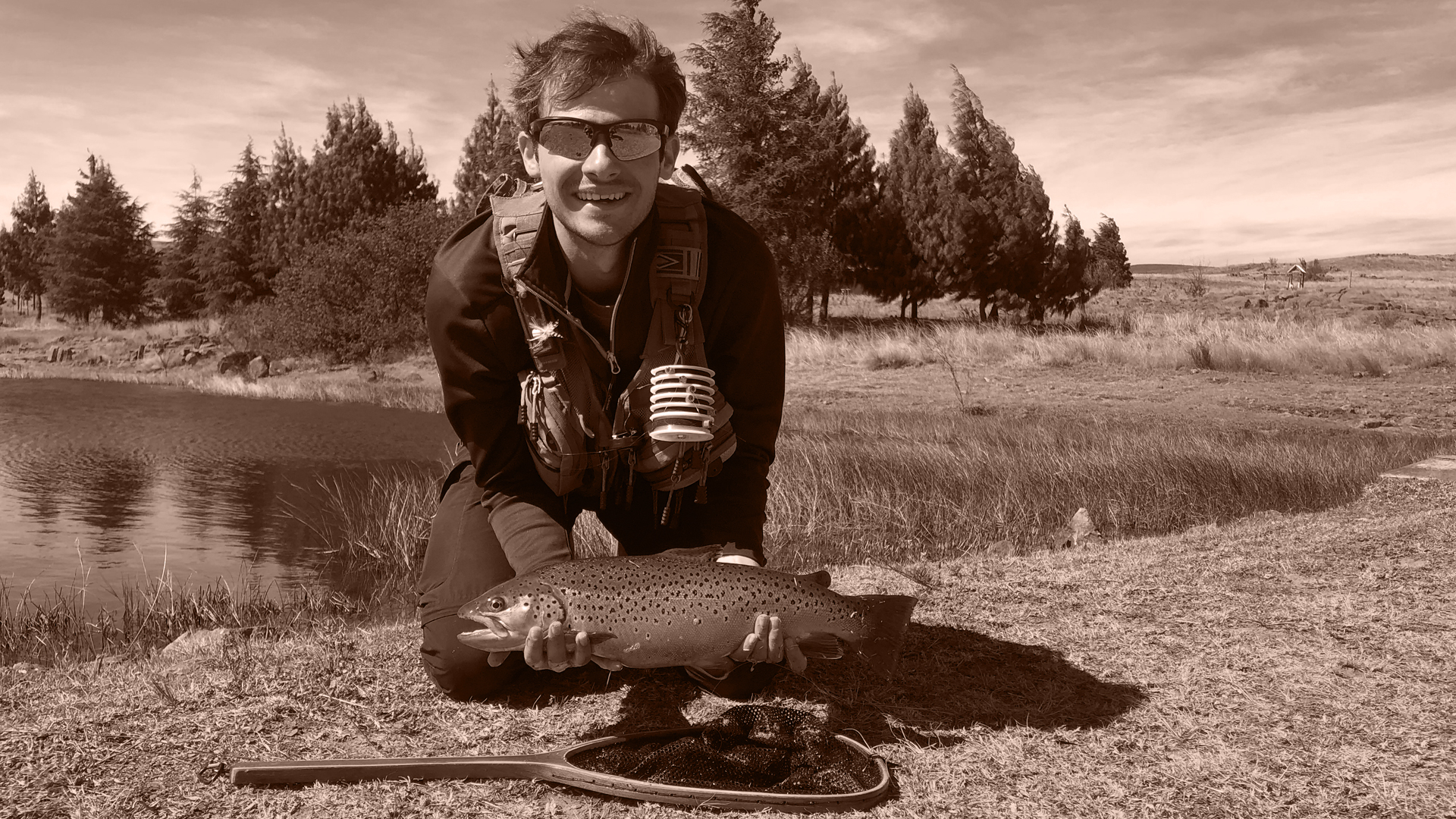 Lanzo holding a fish he caught with fly fishing